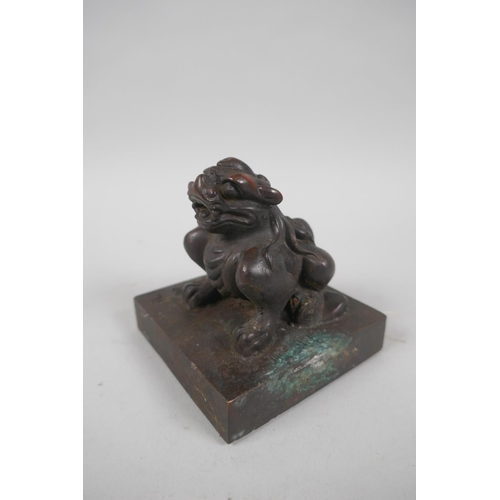 138 - A Chinese filled bronze seal with kylin knop, 8 x 8cm