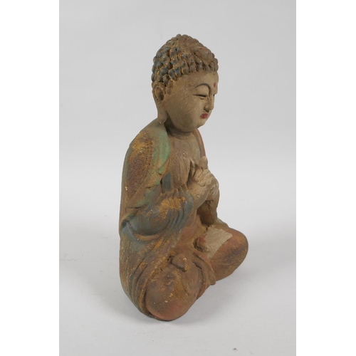 139 - A Chinese carved, painted and distressed wood figure of Buddha, 23cm high