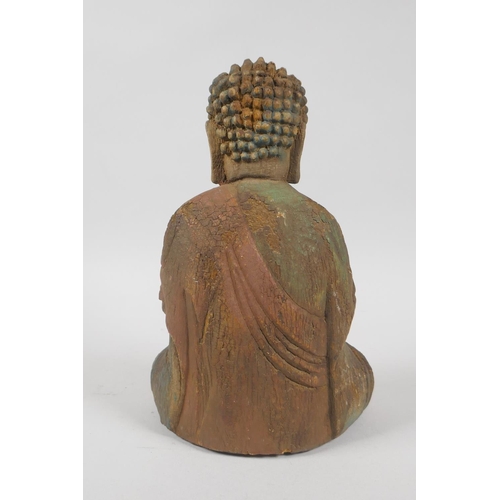 139 - A Chinese carved, painted and distressed wood figure of Buddha, 23cm high