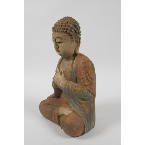 139 - A Chinese carved, painted and distressed wood figure of Buddha, 23cm high