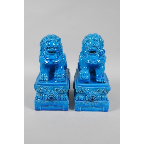 140 - A pair of Chinese turquoise glazed porcelain fo-dogs, impressed marks to base, 21cm high