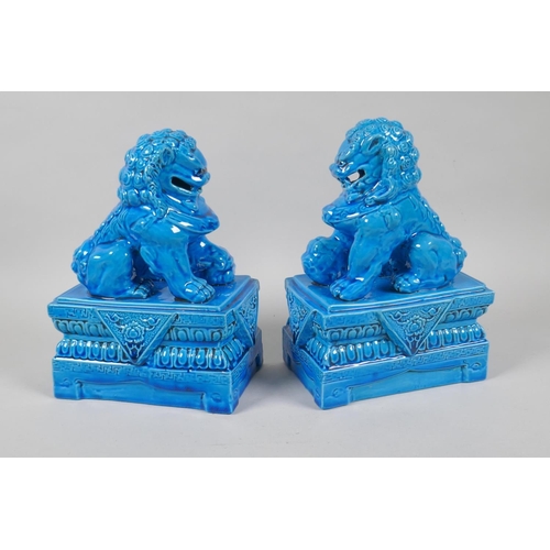 140 - A pair of Chinese turquoise glazed porcelain fo-dogs, impressed marks to base, 21cm high