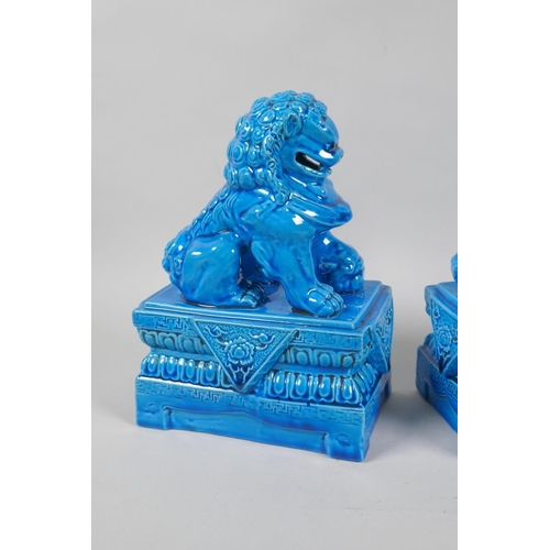 140 - A pair of Chinese turquoise glazed porcelain fo-dogs, impressed marks to base, 21cm high