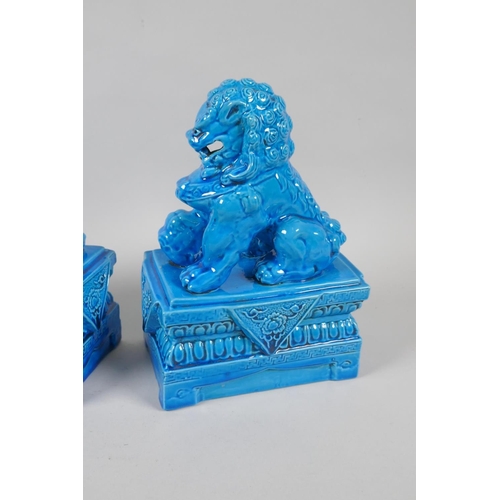 140 - A pair of Chinese turquoise glazed porcelain fo-dogs, impressed marks to base, 21cm high