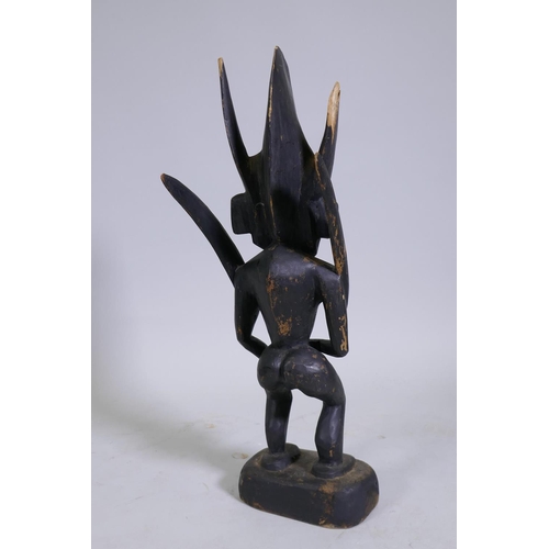 141 - An African tribal carved and ebonised wood fertility figure with shell eyes, 55cm high 