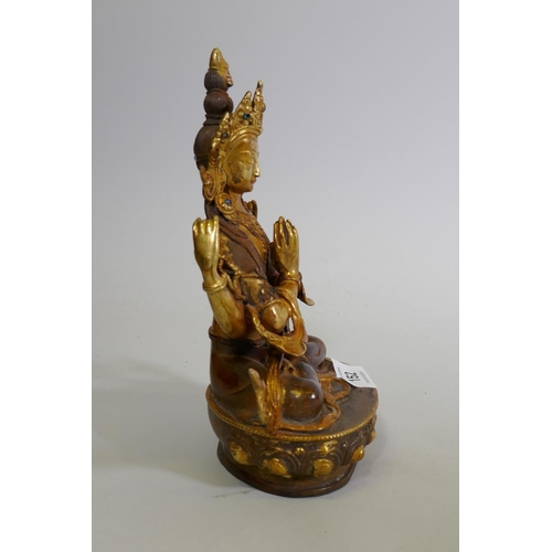 152 - A gilt bronze Buddhistic figure with inset bead decoration, 22cm high