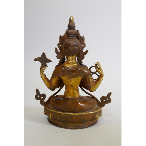 152 - A gilt bronze Buddhistic figure with inset bead decoration, 22cm high