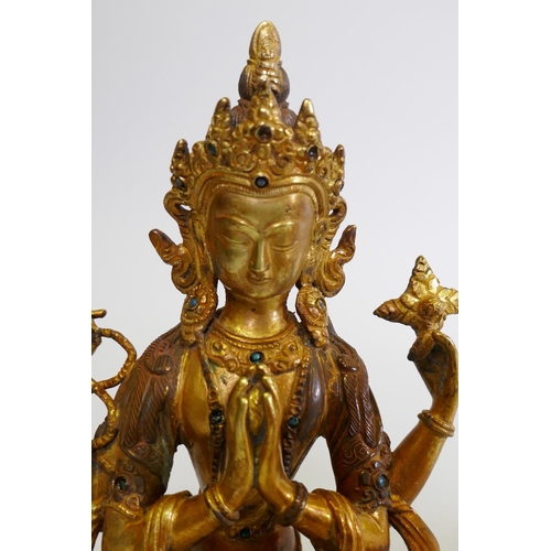 152 - A gilt bronze Buddhistic figure with inset bead decoration, 22cm high