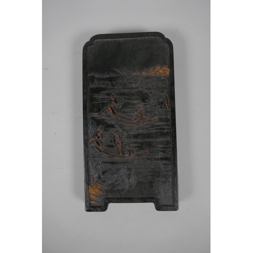 165 - A Chinese black ink stone with raised decoration of figures boating, boxed, 11 x 21cm