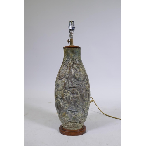 169 - A Chinese bronze table lamp, the body with raised decoration depicting immortals amongst clouds, mou... 