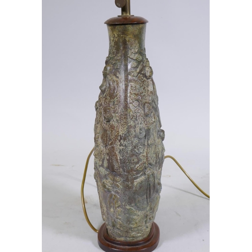 169 - A Chinese bronze table lamp, the body with raised decoration depicting immortals amongst clouds, mou... 