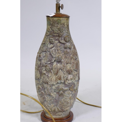 169 - A Chinese bronze table lamp, the body with raised decoration depicting immortals amongst clouds, mou... 