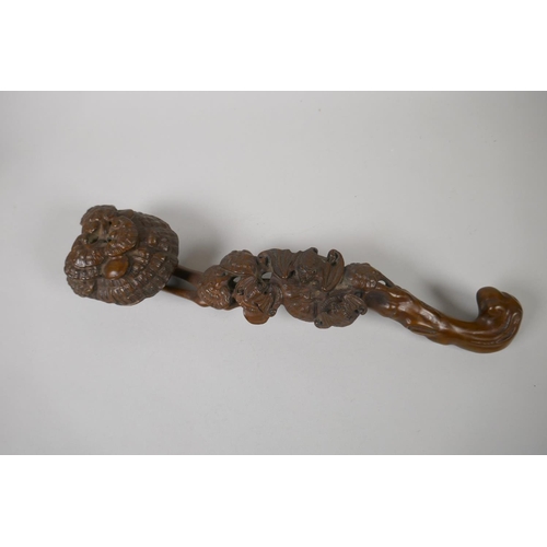 176 - A Chinese carved and pierced boxwood ruyi, 34cm long