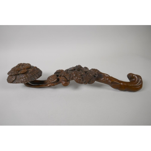 176 - A Chinese carved and pierced boxwood ruyi, 34cm long