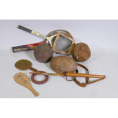 181 - Vintage rugby and foot balls, badminton racquets etc