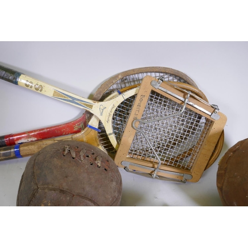 181 - Vintage rugby and foot balls, badminton racquets etc