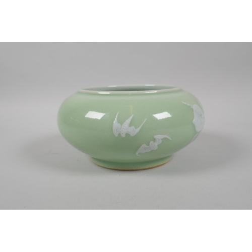 183 - A Chinese celadon glazed porcelain bowl with rolled rim, with raised enamel peach tree and bat decor... 