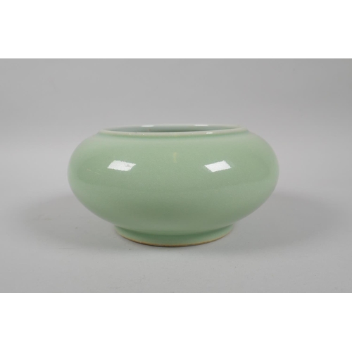 183 - A Chinese celadon glazed porcelain bowl with rolled rim, with raised enamel peach tree and bat decor... 