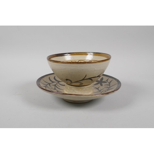 189 - A Chinese Cizhou kiln tea bowl and saucer with phoenix and floral decoration, saucer 15cm diameter