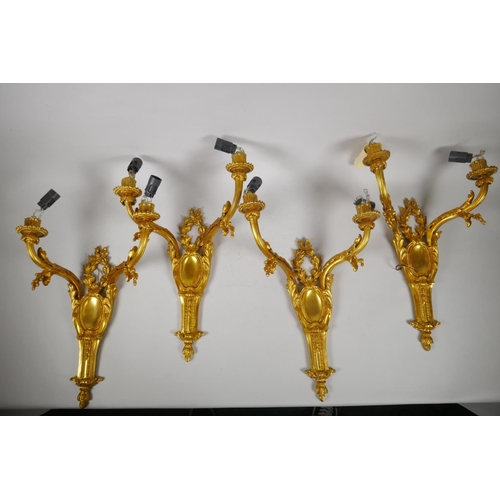 194 - Two pairs of ormolu two branch wall sconces with leaf decoration, 45cm 