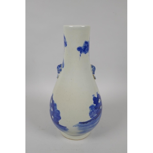 196 - A Chinese blue and white porcelain vase with two mask handles, decorated with figures in a landscape... 