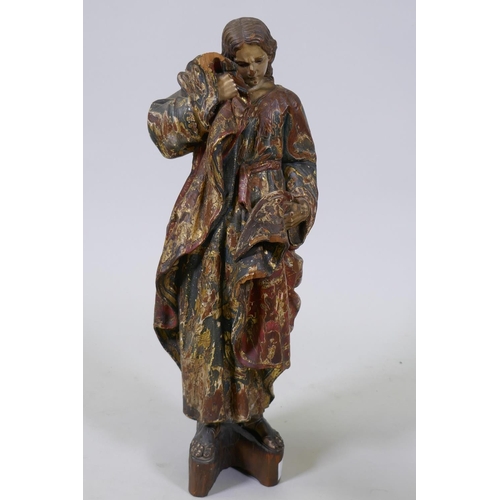 2 - A carved limewood figure of Saint John with polychrome and parcel gilt decoration and glass eyes, pr... 