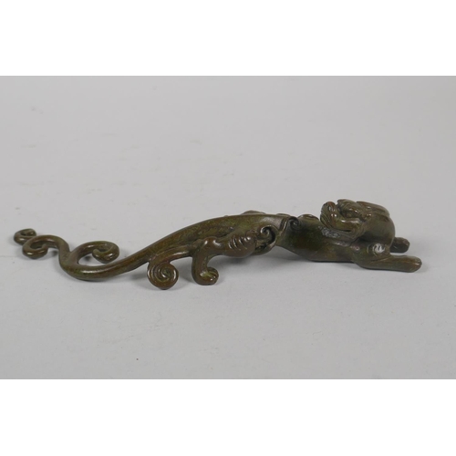 203 - A Chinese miniature bronze figure of a dragon, 16cm long