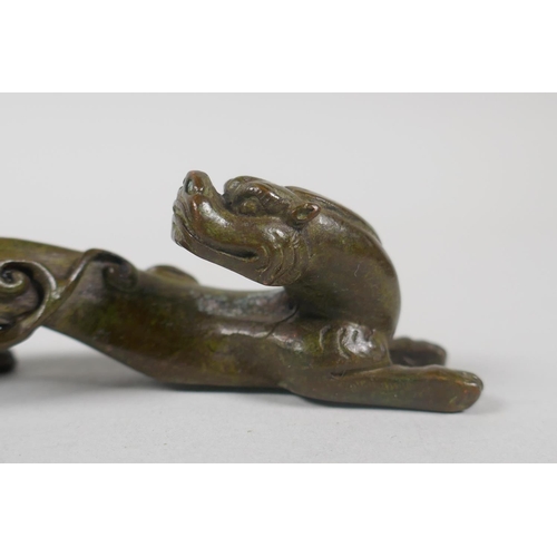 203 - A Chinese miniature bronze figure of a dragon, 16cm long