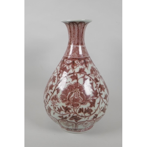 206 - A Chinese red and white porcelain pear shaped vase with scrolling lotus flower decoration, 32cm high