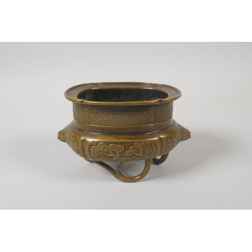 216 - A Chinese bronze censer with two lion mask handles and raised on bamboo feet, 8cm high