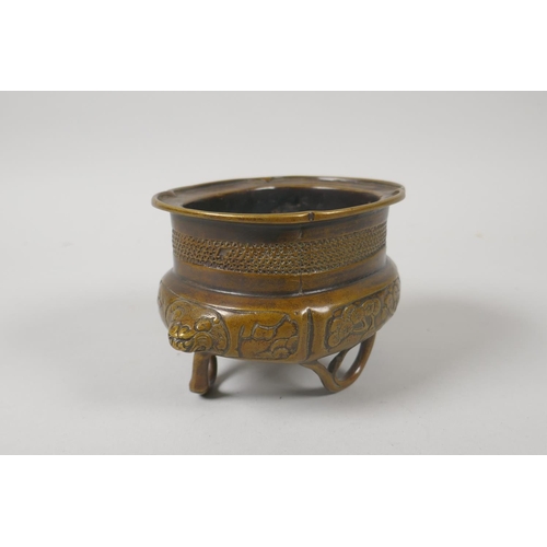 216 - A Chinese bronze censer with two lion mask handles and raised on bamboo feet, 8cm high