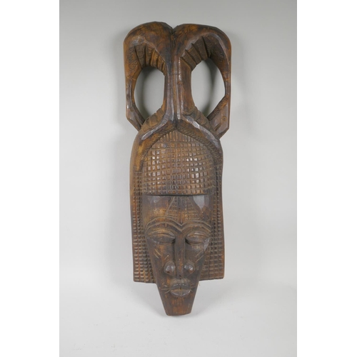 219 - An African carved wood wall mask, and a congolese carved wood figure of a mother and child, largest ... 