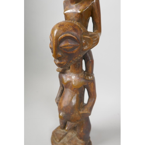 219 - An African carved wood wall mask, and a congolese carved wood figure of a mother and child, largest ... 