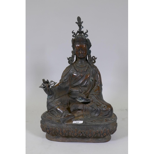 22 - A large hollow cast bronze figure of Buddha bearing a vajra, 49cm high