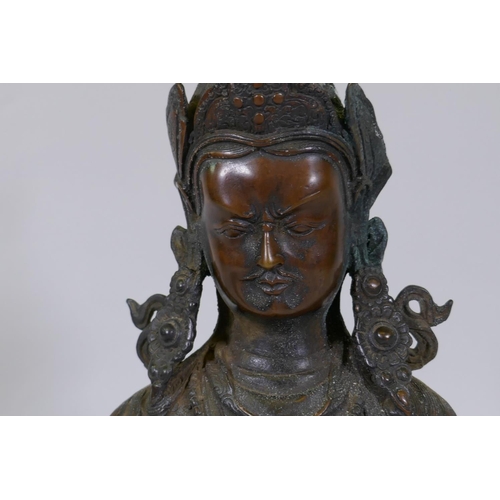 22 - A large hollow cast bronze figure of Buddha bearing a vajra, 49cm high