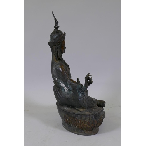 22 - A large hollow cast bronze figure of Buddha bearing a vajra, 49cm high