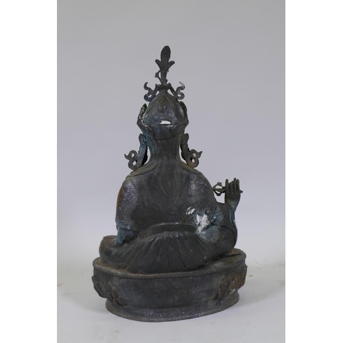 22 - A large hollow cast bronze figure of Buddha bearing a vajra, 49cm high