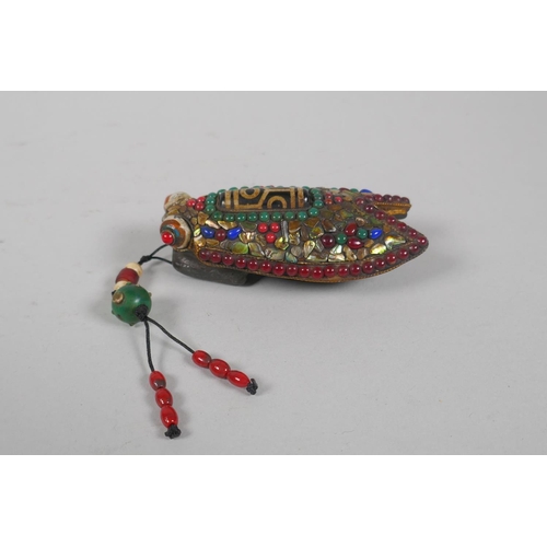 223 - A Tibetan abalone, jade, coral and gemstone encrusted cast iron toggle, in the form of a cicada, 9cm... 