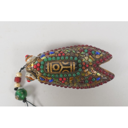 223 - A Tibetan abalone, jade, coral and gemstone encrusted cast iron toggle, in the form of a cicada, 9cm... 