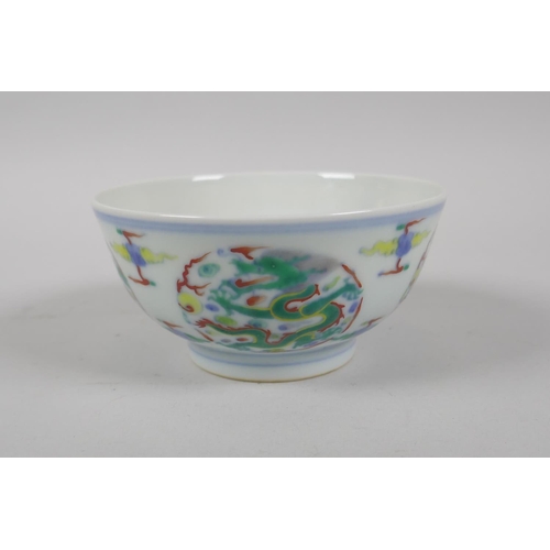 224 - A Chinese Doucai porcelain rice bowl with dragon decoration, YongZheng 6 character mark to base, 11c... 