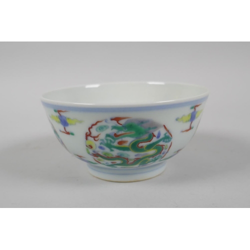 224 - A Chinese Doucai porcelain rice bowl with dragon decoration, YongZheng 6 character mark to base, 11c... 