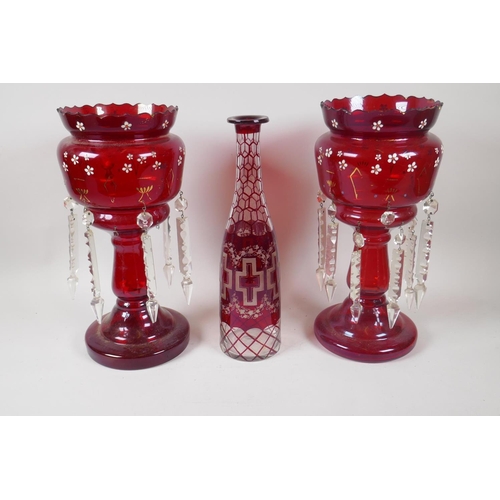 225 - A pair of Victorian ruby glass lustres with lobed rim, and a bohemian ruby glass bottle with etched ... 