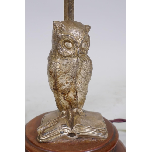 228 - A vintage silvered metal table lamp in the form of an owl perched on an open book, mounted on a wood... 