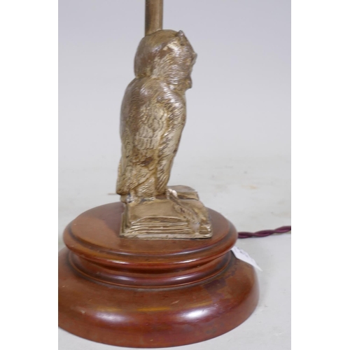 228 - A vintage silvered metal table lamp in the form of an owl perched on an open book, mounted on a wood... 