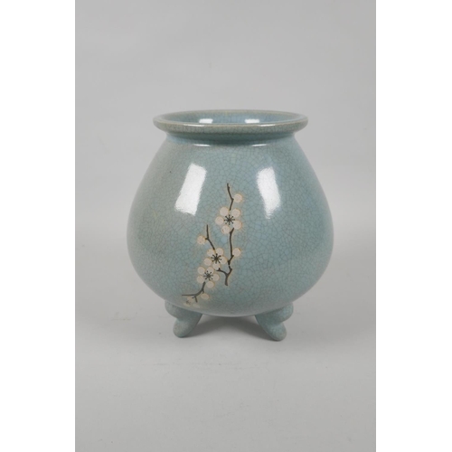 235 - A Chinese celadon crackle glaze jar on tripod supports with floral decoration, 19cm high