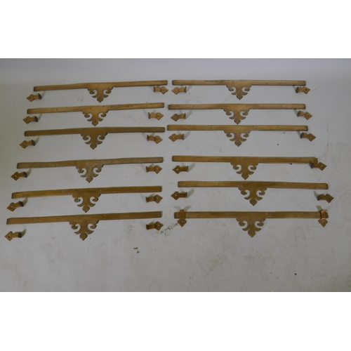 24 - Twelve C19th bronze stair rods, 64.5 x 10cm, 6+mm thick, with fleur de lys decoration, brackets 7cm ... 