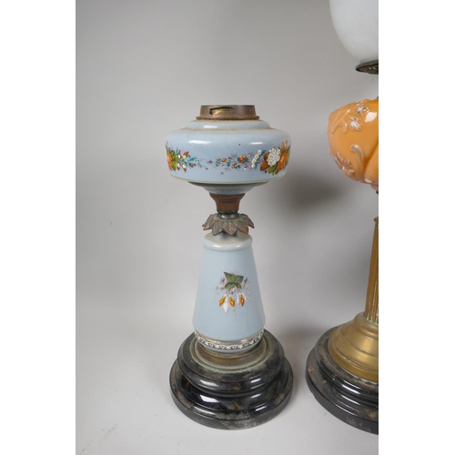 242 - Five C19th and early C20th oil lamps with glass reservoirs and shades, and a quantity of oil lamp ch... 