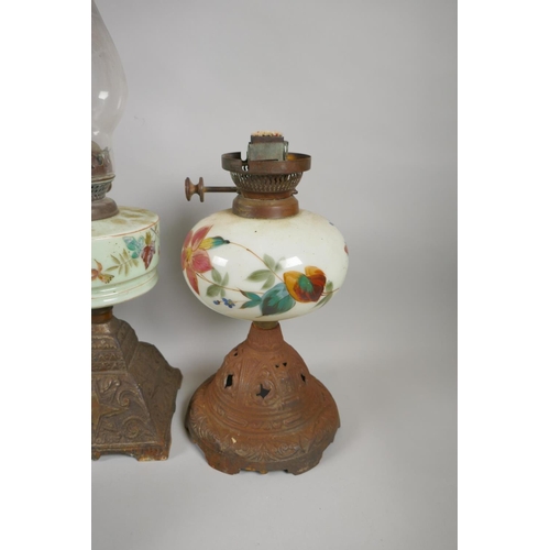 242 - Five C19th and early C20th oil lamps with glass reservoirs and shades, and a quantity of oil lamp ch... 