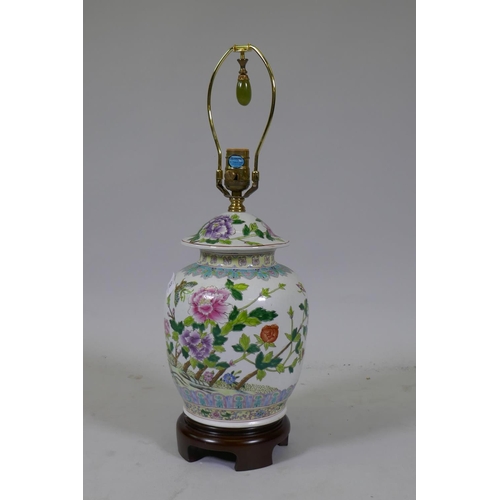 52 - A Chinese famille verte jar and cover, converted to a table lamp, mounted on a wood base, 57cm high