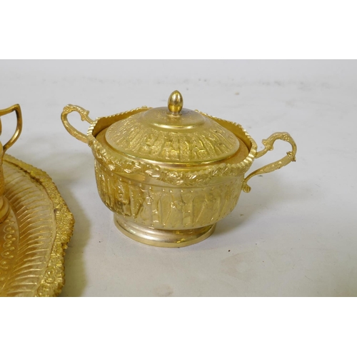 53 - A Middle Eastern gilt metal serving tray with fitted sugar bowl and twelve glass beakers with holder... 